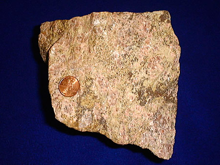 一个稀土矿石，有一个分硬币进行比较，照片：USGS
